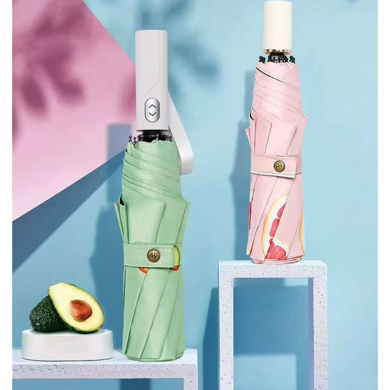 How does the easy-to-clean feature of the vinyl pink triple fold umbrella make it convenient to deal with stains after rain?